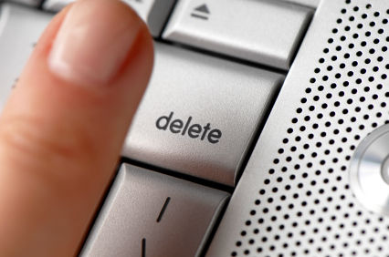 A woman's finger hovering over the delete key